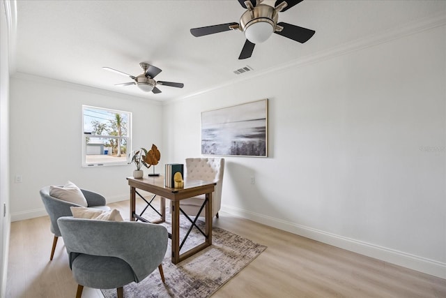 office area featuring crown molding, baseboards, visible vents, and light wood finished floors