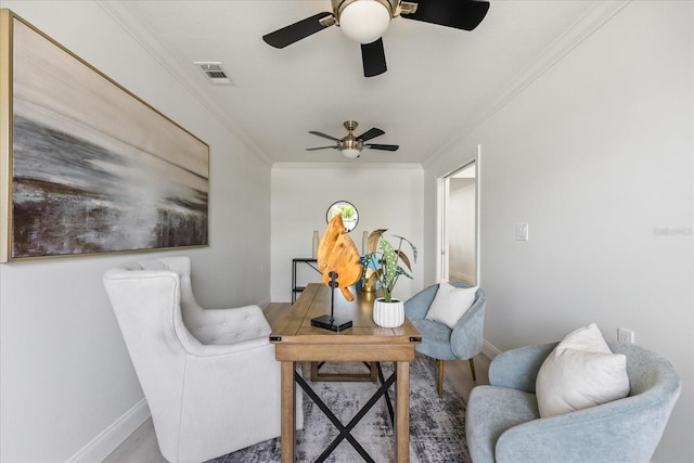 living area featuring a ceiling fan, baseboards, visible vents, crown molding, and wood finished floors