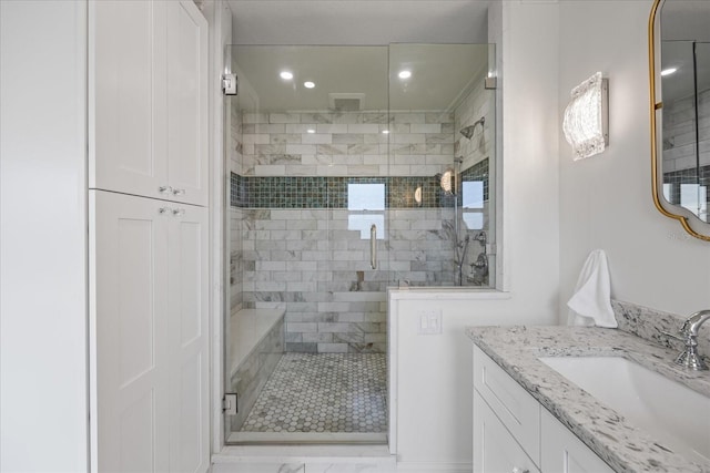 bathroom featuring vanity, a shower stall, and recessed lighting