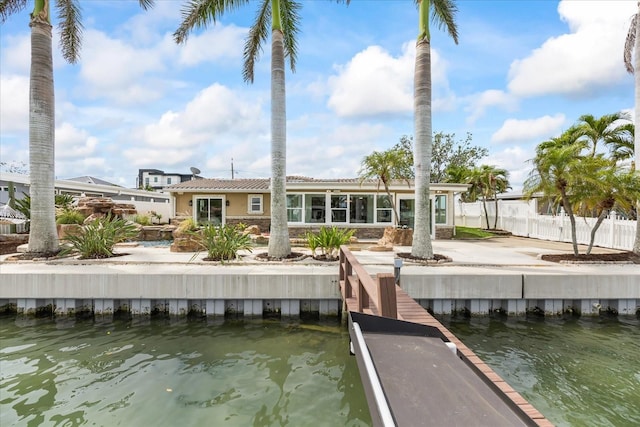 dock area featuring a water view and fence