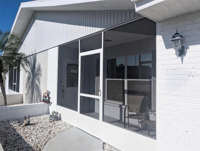 doorway to property with brick siding