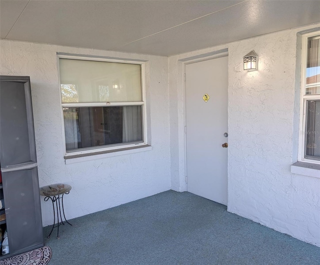 property entrance featuring stucco siding