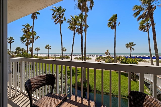 balcony with view of water and beach