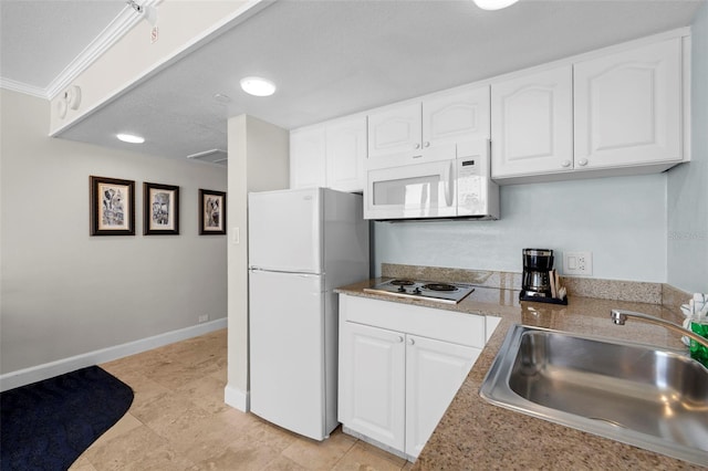 kitchen with white appliances, a sink, white cabinetry, and light countertops