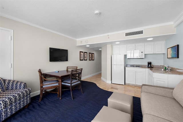 living room featuring ornamental molding, baseboards, and a textured ceiling