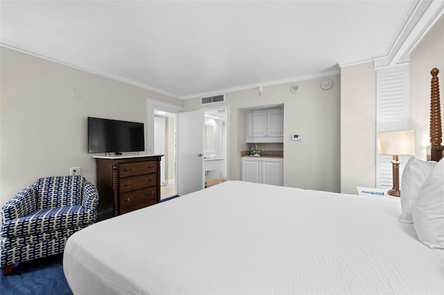 bedroom with crown molding, ensuite bathroom, and dark colored carpet