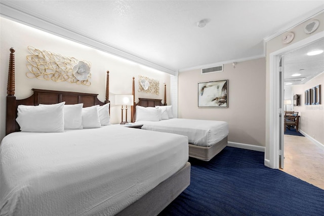 bedroom with baseboards, crown molding, and carpet floors