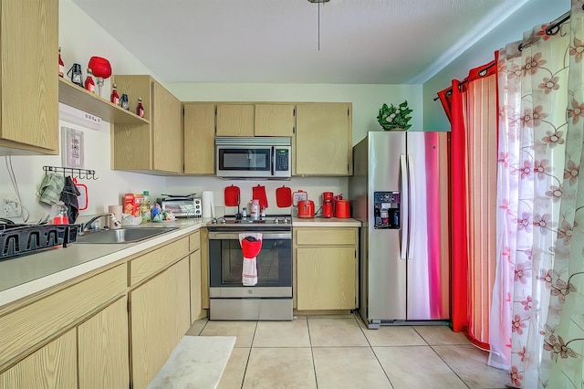 56 Pine Trak Unit 101E, Ocala, FL 34472 - kitchen featuring light countertops, light tile patterned flooring, appliances with stainless steel finishes, and a sink