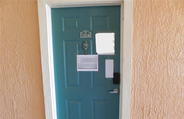 property entrance with stucco siding