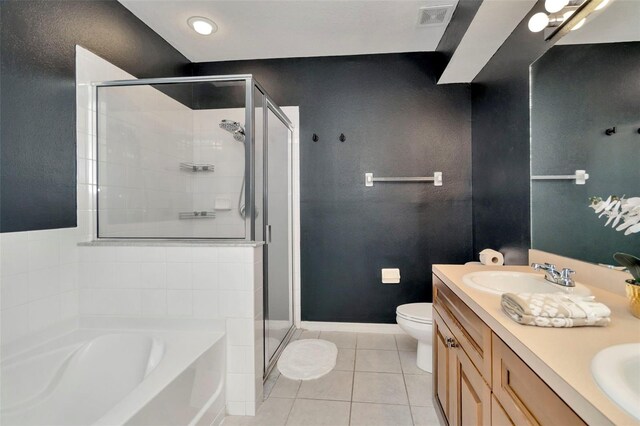 bathroom with tile patterned flooring, a shower stall, a garden tub, and toilet