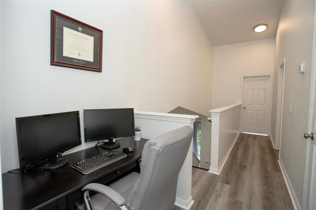 home office featuring wood finished floors and baseboards