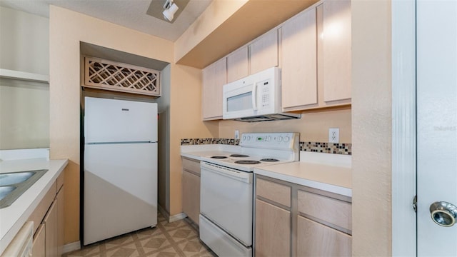 8517 Island Breeze Ln Unit 106, Temple Terrace, FL 33637 - kitchen with a sink, light countertops, light floors, and white appliances