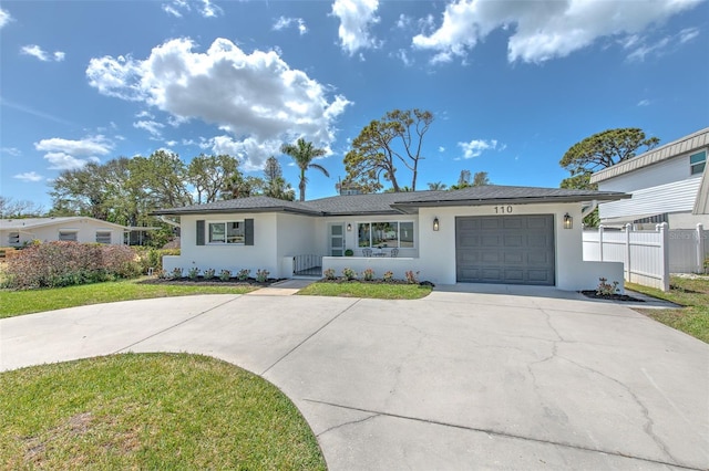 single story home featuring a garage, fence, stucco siding, and driveway