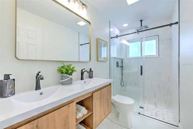 bathroom featuring a sink, a shower stall, toilet, and double vanity