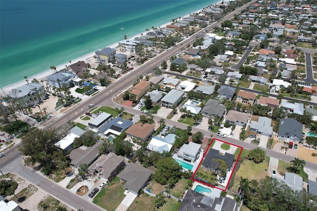 bird's eye view featuring a water view, a beach view, and a residential view