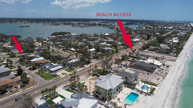 birds eye view of property with a water view, a residential view, and a view of the beach