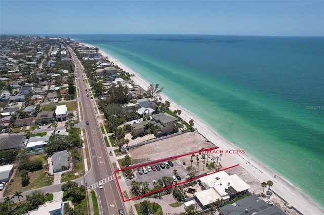 drone / aerial view with a water view, a view of the beach, and a residential view