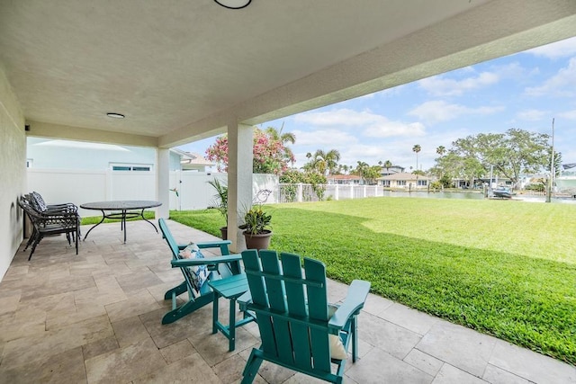 view of patio with a water view and a fenced backyard