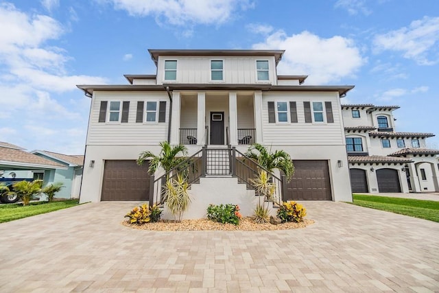 16025 Redington Dr, Redington Beach, FL 33708 - view of front of house with an attached garage, decorative driveway, and stucco siding
