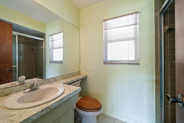 full bath with toilet, tiled shower, tile patterned floors, and vanity