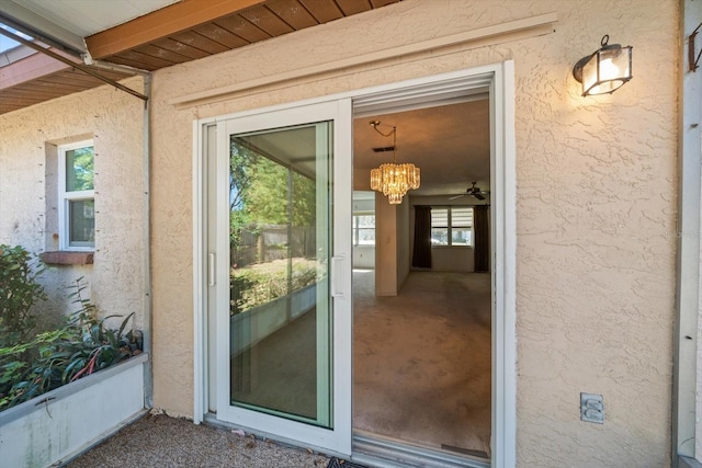 view of exterior entry featuring stucco siding