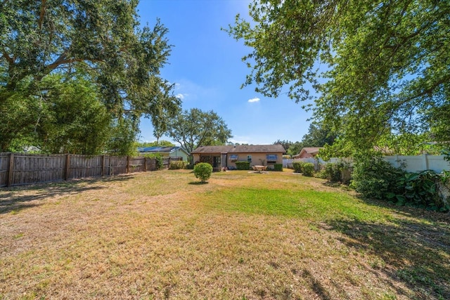 view of yard with a fenced backyard