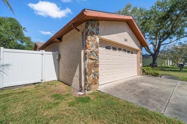 view of home's exterior featuring a lawn, a garage, stucco siding, concrete driveway, and stone siding