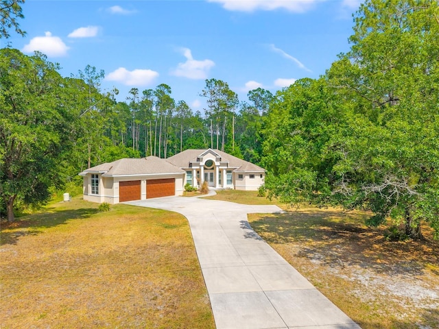 7340 W Dr, Wesley Chapel, FL 33544 - view of front of house with concrete driveway, stucco siding, an attached garage, and a front yard