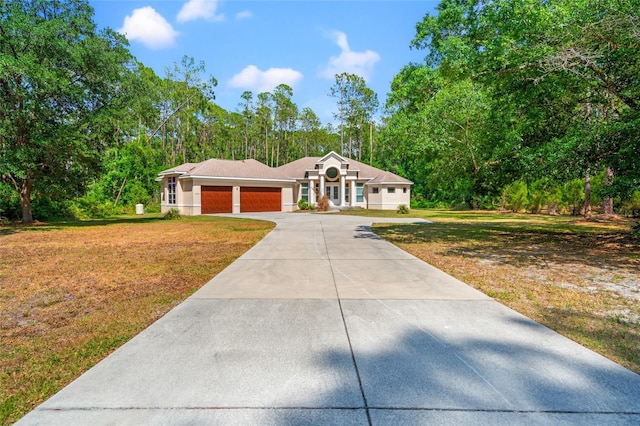 7340 W Dr, Wesley Chapel, FL 33544 - view of front of property with a front lawn, driveway, and a garage