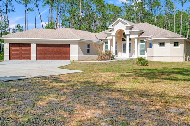 7340 W Dr, Wesley Chapel, FL 33544 - view of front of property featuring a garage, stucco siding, concrete driveway, a shingled roof, and a front lawn