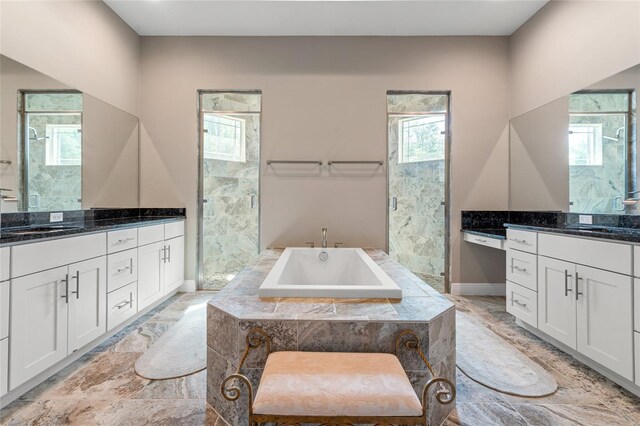 7340 W Dr, Wesley Chapel, FL 33544 - full bathroom with plenty of natural light, a shower stall, two vanities, and a sink