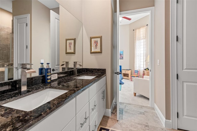 7340 W Dr, Wesley Chapel, FL 33544 - bathroom with double vanity, marble finish floor, baseboards, and a sink
