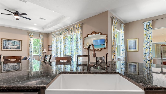 7340 W Dr, Wesley Chapel, FL 33544 - kitchen with a ceiling fan, dishwasher, visible vents, a sink, and dark stone counters