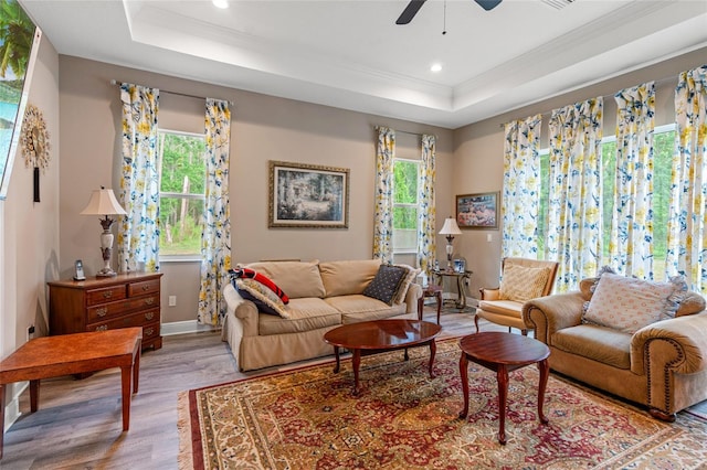 7340 W Dr, Wesley Chapel, FL 33544 - living room featuring a tray ceiling, crown molding, a ceiling fan, and wood finished floors