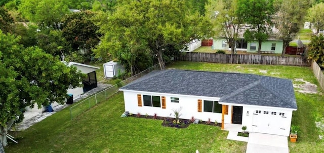 single story home with roof with shingles, a front lawn, and a fenced backyard