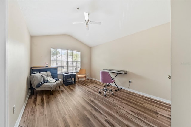 living area featuring ceiling fan, wood finished floors, vaulted ceiling, and baseboards