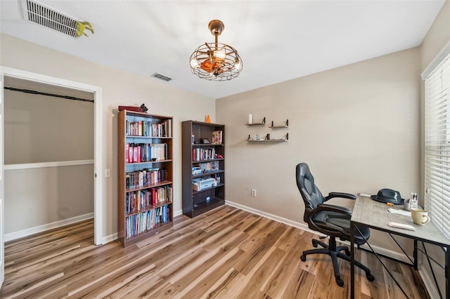 home office featuring wood finished floors and baseboards