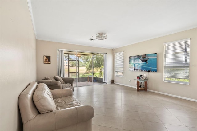 living room with crown molding, light tile patterned floors, and baseboards