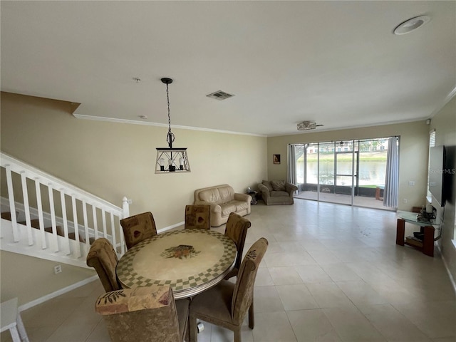 dining room featuring crown molding and baseboards
