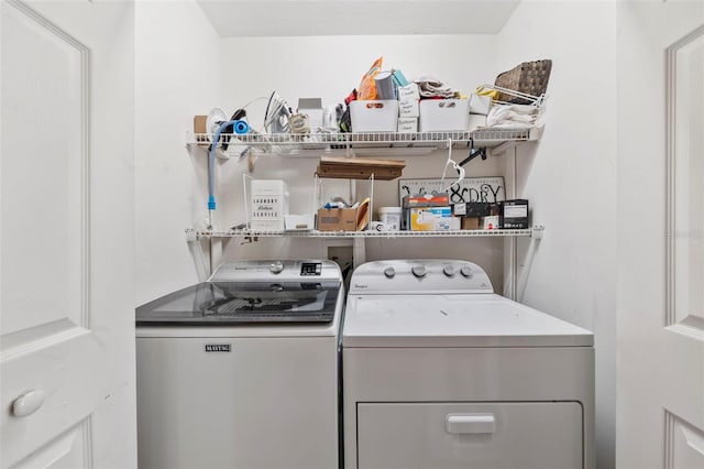 clothes washing area featuring independent washer and dryer