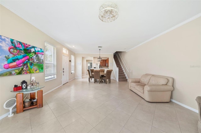 living area with light tile patterned floors, baseboards, and ornamental molding