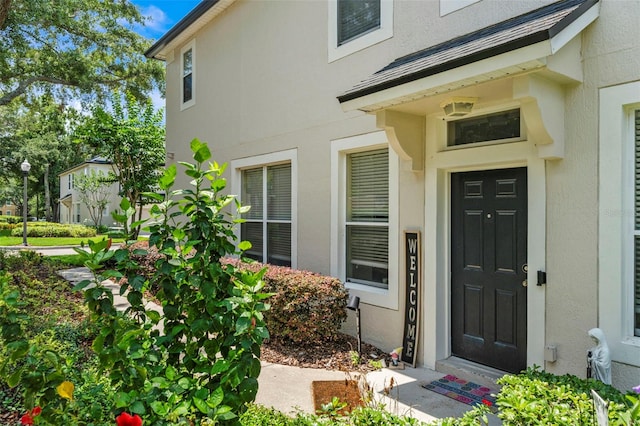 property entrance featuring stucco siding