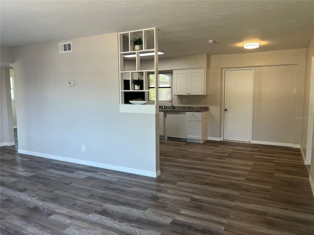 kitchen featuring baseboards, dark wood-type flooring, and dishwasher