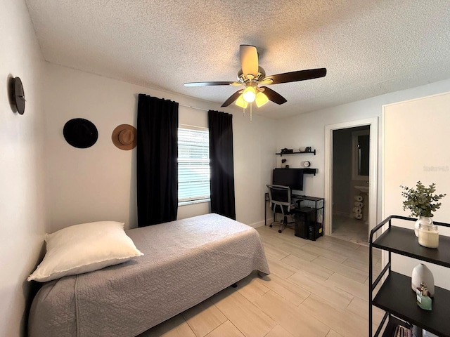 bedroom with a textured ceiling, ceiling fan, and ensuite bathroom
