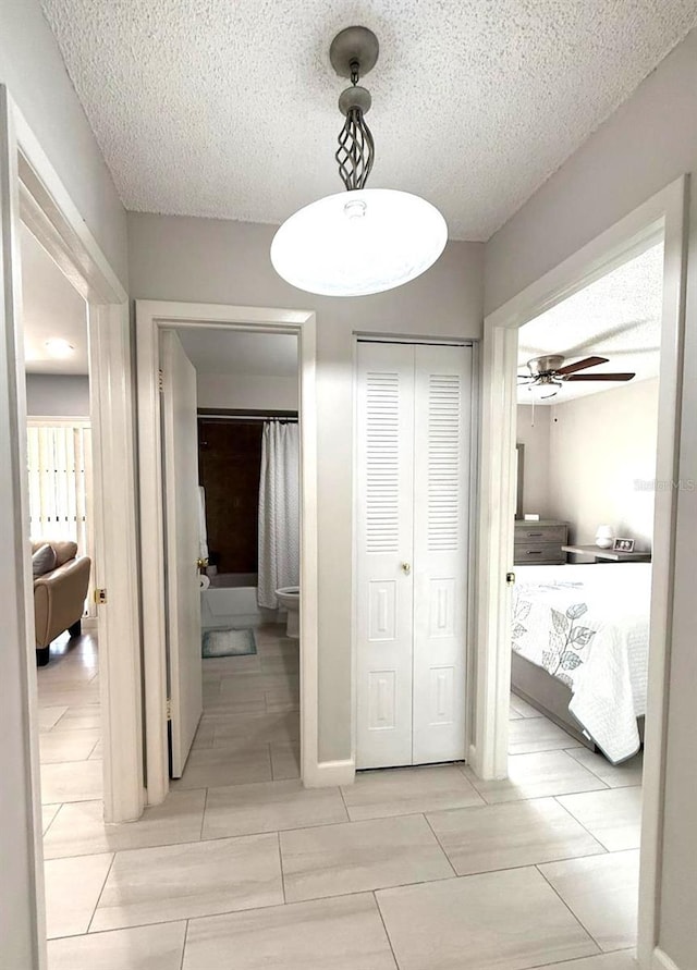 hallway featuring a textured ceiling