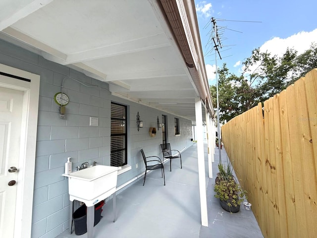 view of patio / terrace featuring fence