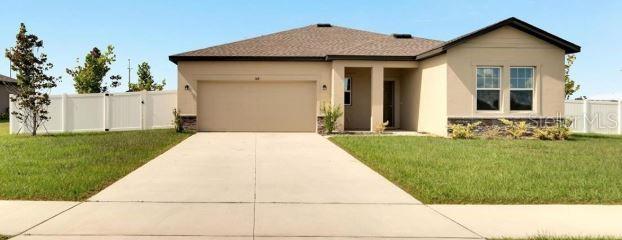 1418 Bluejack Oak Dr, Seffner, FL 33584 - view of front of house featuring concrete driveway, an attached garage, a front yard, and stucco siding