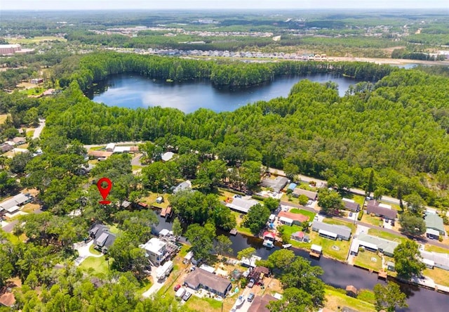 aerial view featuring a water view, a view of trees, and a residential view