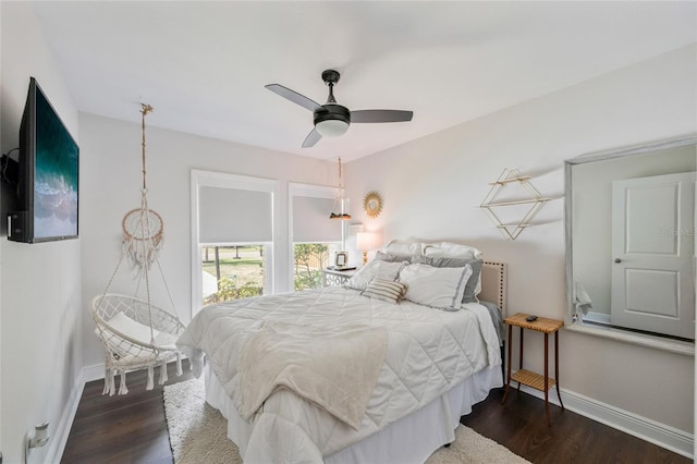 bedroom featuring baseboards, a ceiling fan, and dark wood finished floors
