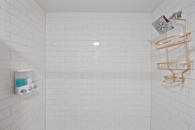 full bath with a tile shower